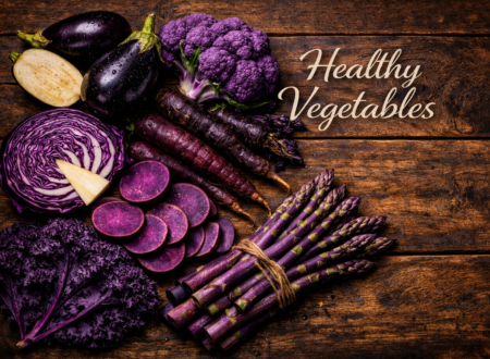 purple vegetables variety including eggplant cabbage carrots and sweet potatoes on table